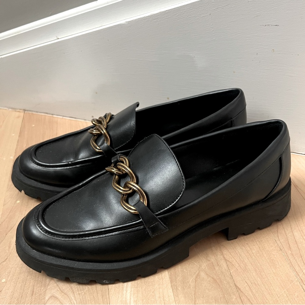 Black loafers with gold chain detail